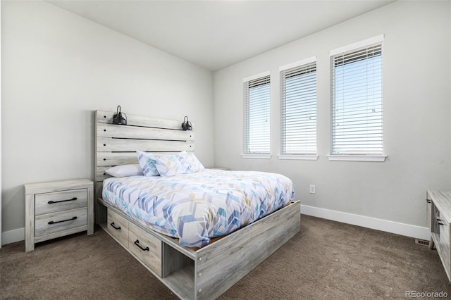 bedroom featuring dark colored carpet