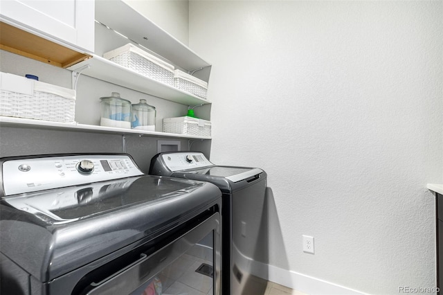 laundry area featuring tile patterned flooring and washer and dryer