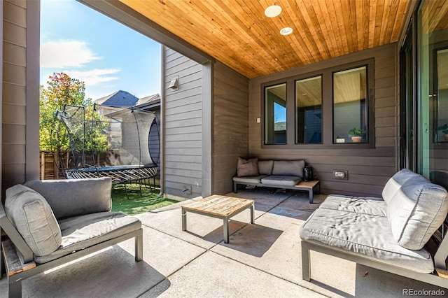 view of patio / terrace featuring a trampoline and an outdoor living space