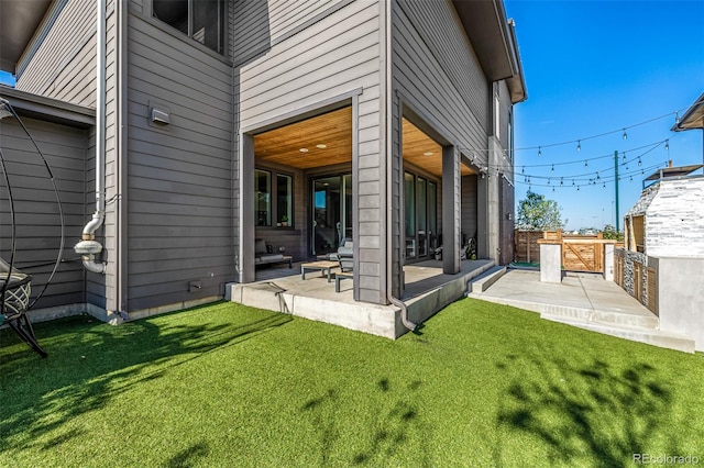 rear view of property with a patio area and a lawn