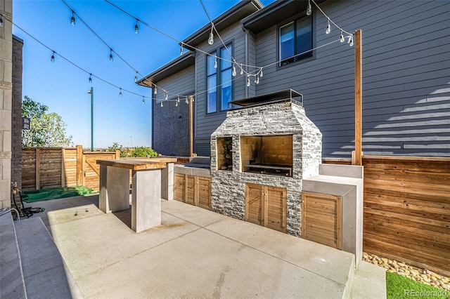 view of patio featuring an outdoor stone fireplace