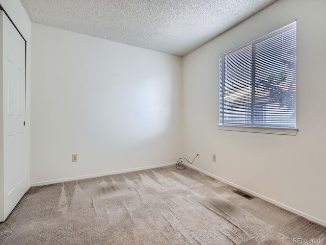 17681 E Loyola Dr Unit E, Aurora, CO 80013 - unfurnished bedroom with a textured ceiling, carpet, and a closet