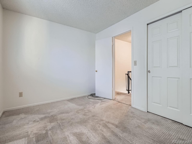 17681 E Loyola Dr Unit E, Aurora, CO 80013 - unfurnished bedroom featuring carpet flooring and a textured ceiling