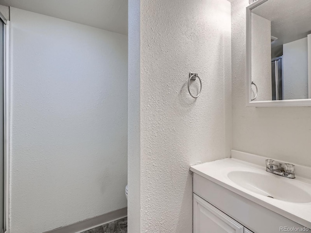 17681 E Loyola Dr Unit E, Aurora, CO 80013 - bathroom with vanity and a textured wall
