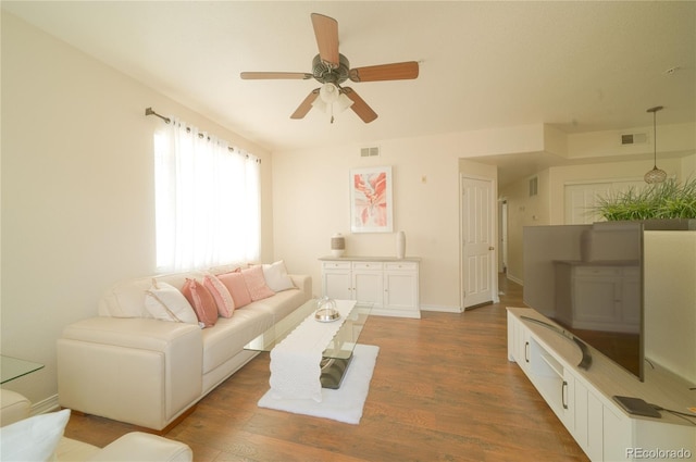 5732 S Addison Way # E, Aurora, CO 80016 - living room featuring ceiling fan, wood finished floors, and baseboards