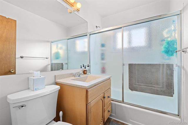 full bathroom with a wealth of natural light, enclosed tub / shower combo, vanity, and toilet