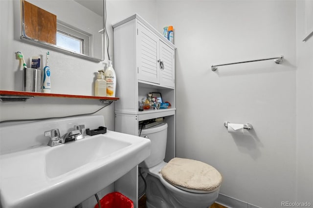 bathroom featuring toilet and sink