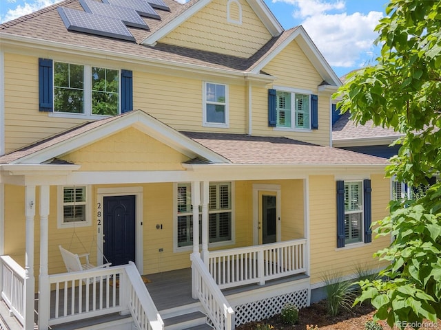 2821 Fulton St, Denver, CO 80238 - view of front of property featuring a porch, a shingled roof, and solar panels
