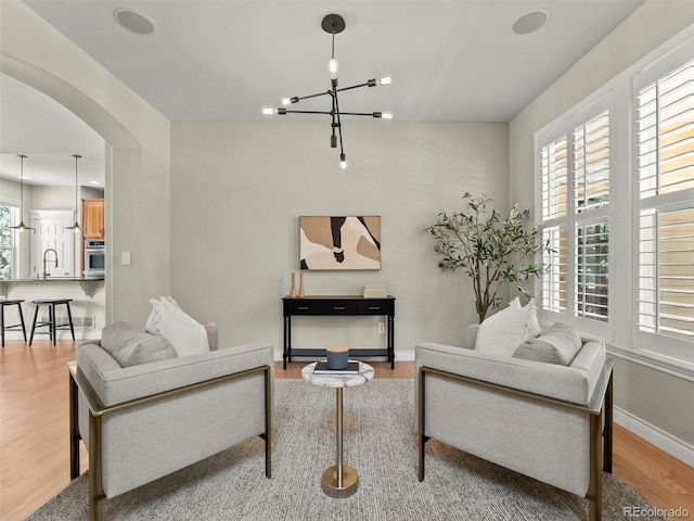 2821 Fulton St, Denver, CO 80238 - living area with arched walkways, wood finished floors, and a chandelier