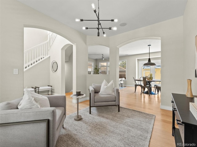 2821 Fulton St, Denver, CO 80238 - living room featuring arched walkways, light wood-type flooring, and a chandelier
