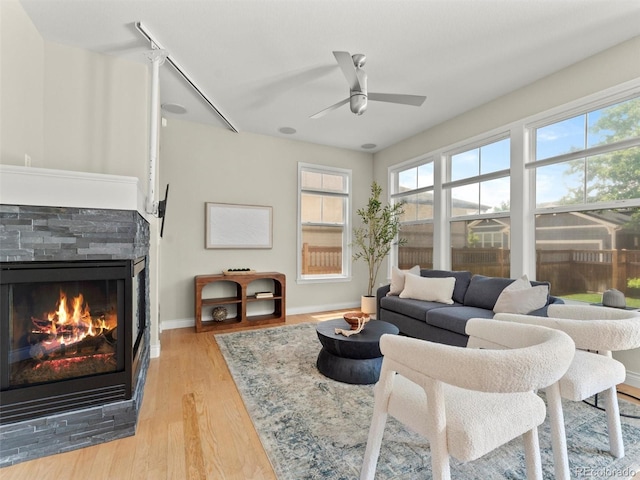 2821 Fulton St, Denver, CO 80238 - living room with a ceiling fan, a glass covered fireplace, and light wood-type flooring