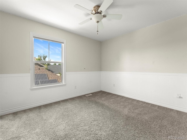2821 Fulton St, Denver, CO 80238 - empty room featuring carpet floors, ceiling fan, and wainscoting