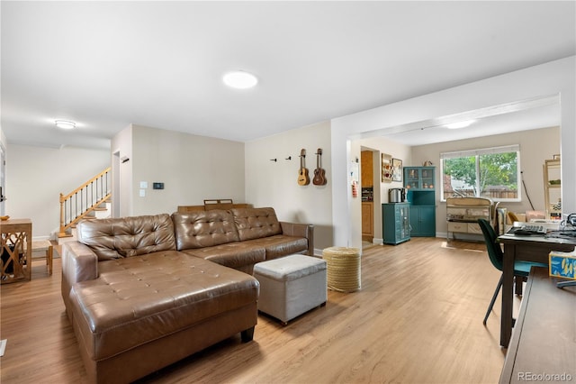 1758 S Tucson St, Aurora, CO 80012 - living area featuring light wood-style flooring and stairs