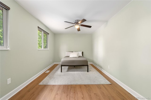 1758 S Tucson St, Aurora, CO 80012 - bedroom with wood finished floors, baseboards, and ceiling fan