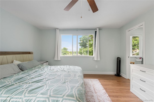 1758 S Tucson St, Aurora, CO 80012 - bedroom with multiple windows, baseboards, light wood-style flooring, and ceiling fan