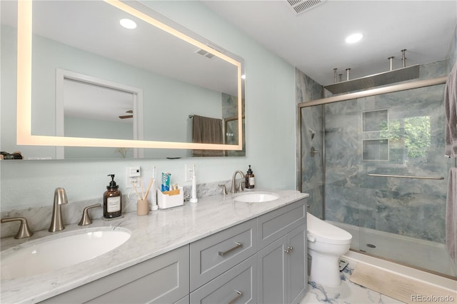 1758 S Tucson St, Aurora, CO 80012 - bathroom featuring a shower stall, double vanity, toilet, marble finish flooring, and recessed lighting
