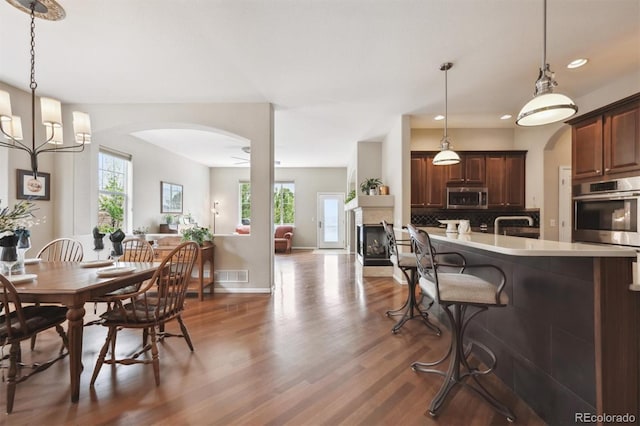 5810 Moss Ct, Golden, CO 80403 - kitchen with stainless steel appliances, plenty of natural light, wood finished floors, backsplash, and recessed lighting