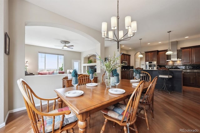 5810 Moss Ct, Golden, CO 80403 - dining area with wood finished floors, a chandelier, arched walkways, ceiling fan, and recessed lighting