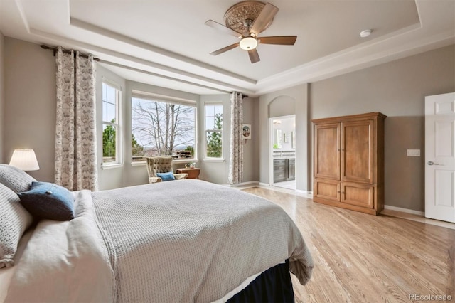 5810 Moss Ct, Golden, CO 80403 - bedroom featuring a tray ceiling, light wood-style flooring, and ceiling fan