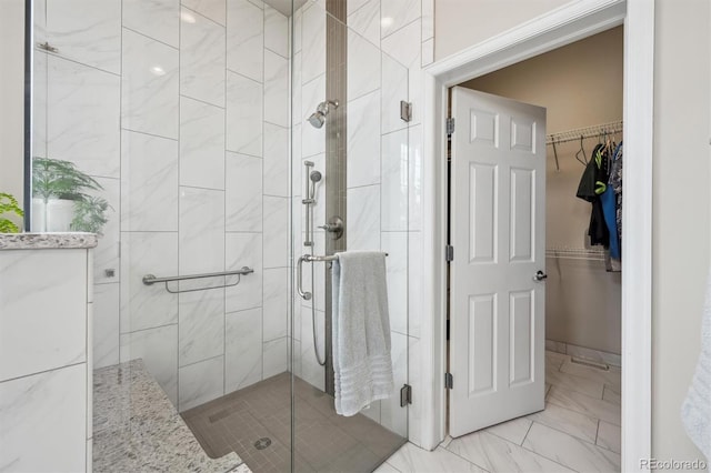 5810 Moss Ct, Golden, CO 80403 - full bathroom with a shower stall, marble finish floors, and a walk in closet