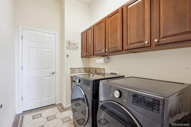 5810 Moss Ct, Golden, CO 80403 - laundry room with cabinet space, washer and clothes dryer, and light tile patterned floors