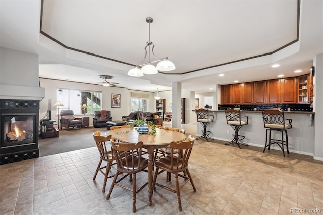 5810 Moss Ct, Golden, CO 80403 - dining area with recessed lighting, a raised ceiling, a multi sided fireplace, crown molding, and a ceiling fan