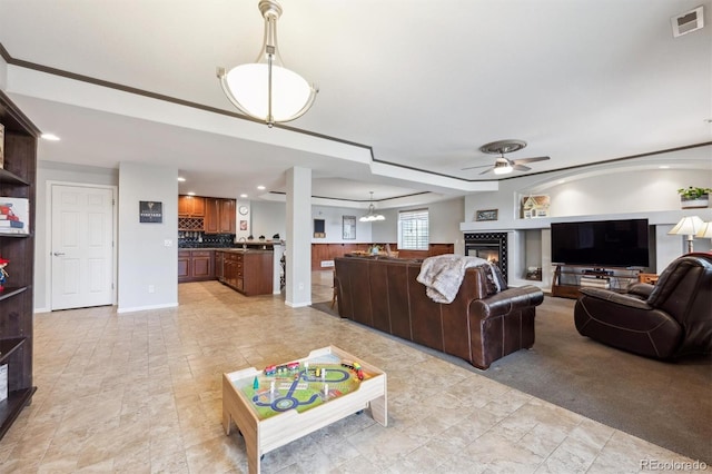 5810 Moss Ct, Golden, CO 80403 - living area featuring ceiling fan, a glass covered fireplace, stone finish flooring, and recessed lighting