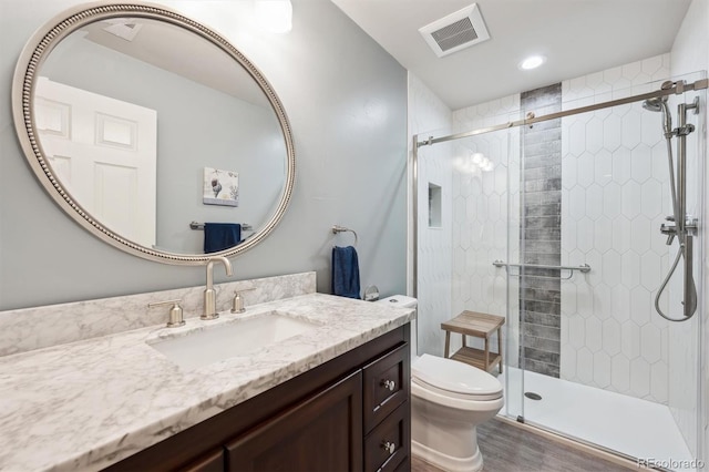 5810 Moss Ct, Golden, CO 80403 - bathroom featuring vanity, a stall shower, wood finished floors, and recessed lighting