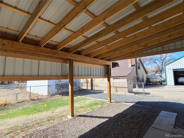 view of patio with a garage and an outbuilding