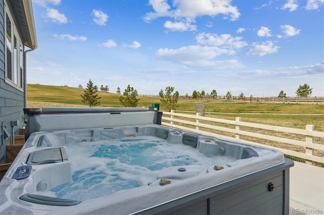 exterior details featuring fence and a hot tub