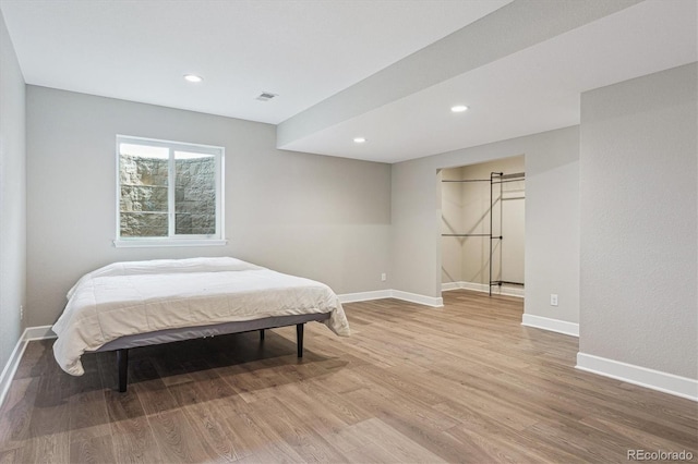 bedroom featuring recessed lighting, baseboards, visible vents, and light wood-type flooring