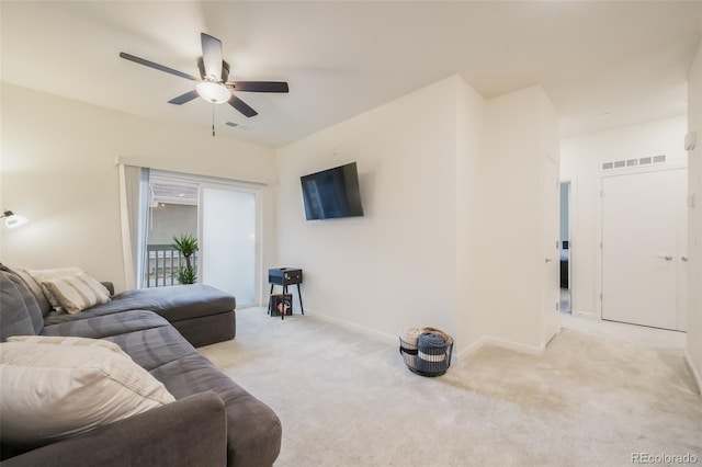 living room with ceiling fan and light colored carpet