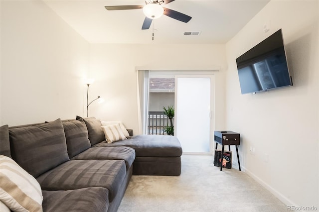 carpeted living room with ceiling fan