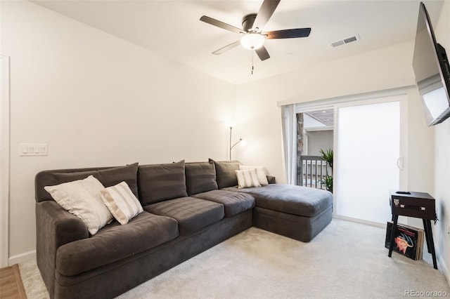 carpeted living room featuring ceiling fan