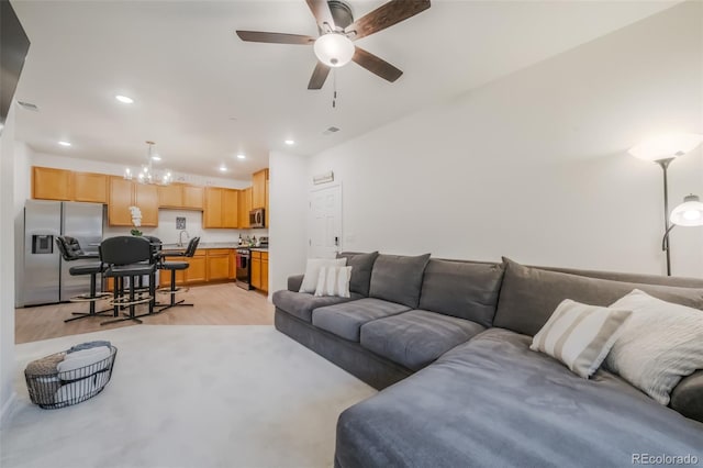 living room with ceiling fan and light hardwood / wood-style floors