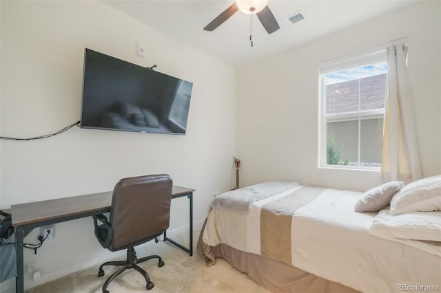 carpeted bedroom with ceiling fan and multiple windows