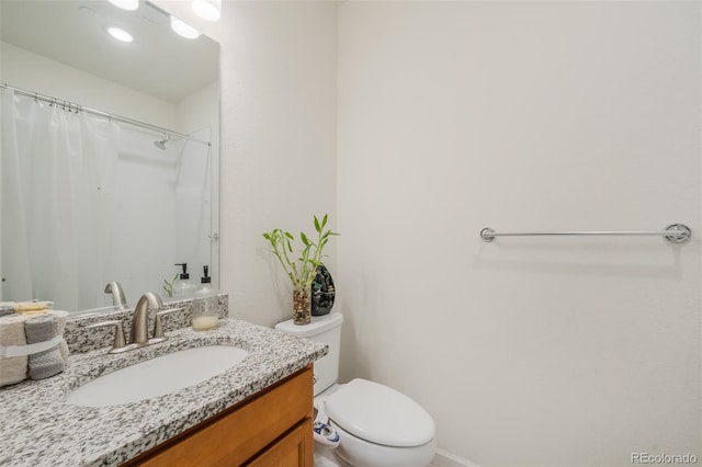 bathroom featuring toilet and vanity