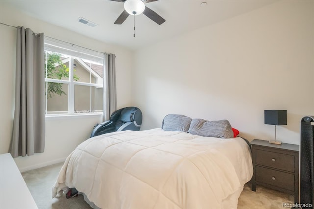 bedroom with ceiling fan and light carpet