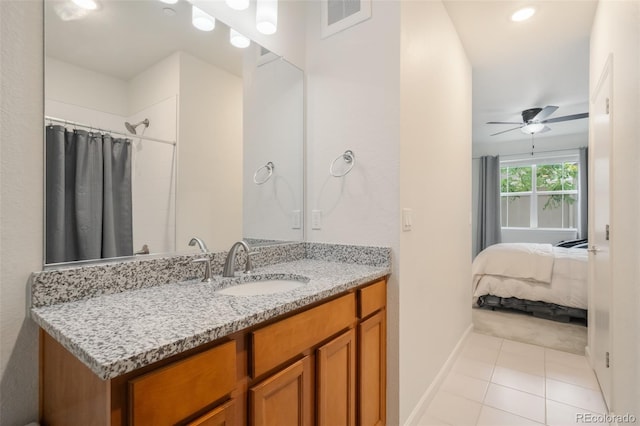 bathroom featuring ceiling fan, tile patterned floors, and vanity