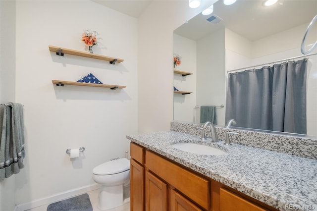 bathroom featuring tile patterned flooring, toilet, and vanity