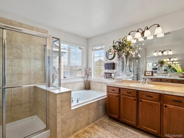 10273 Salida St, Commerce City, CO 80022 - full bath featuring a garden tub, vanity, and a stall shower