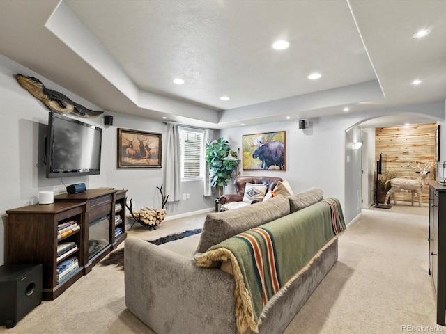 10273 Salida St, Commerce City, CO 80022 - living room featuring light colored carpet, arched walkways, recessed lighting, and baseboards
