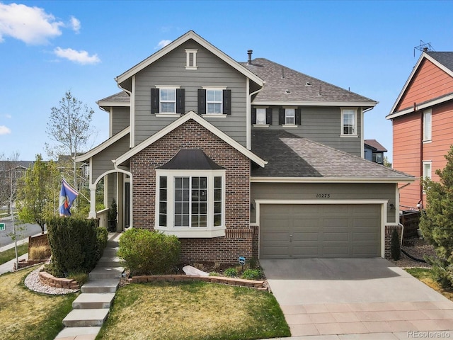 10273 Salida St, Commerce City, CO 80022 - traditional-style home with brick siding, driveway, a garage, and roof with shingles