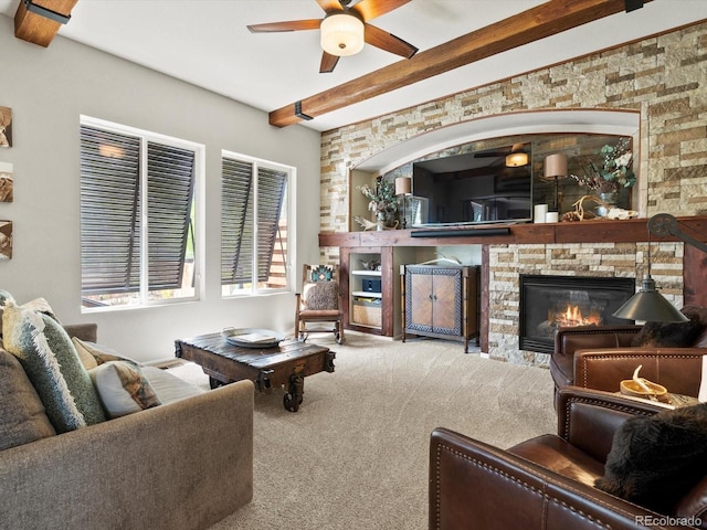 10273 Salida St, Commerce City, CO 80022 - carpeted living room featuring beamed ceiling, a ceiling fan, and a stone fireplace
