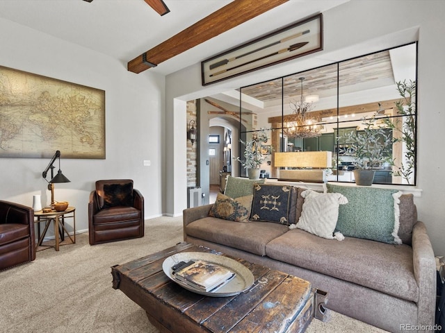 10273 Salida St, Commerce City, CO 80022 - carpeted living room with arched walkways, beam ceiling, baseboards, and ceiling fan with notable chandelier