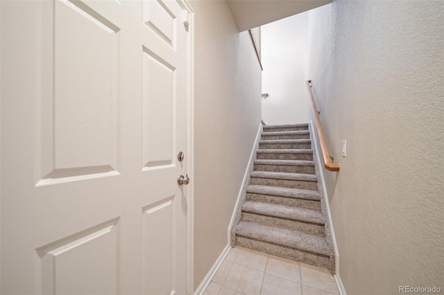 stairs featuring tile patterned flooring