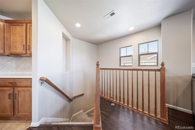 staircase with tile patterned floors