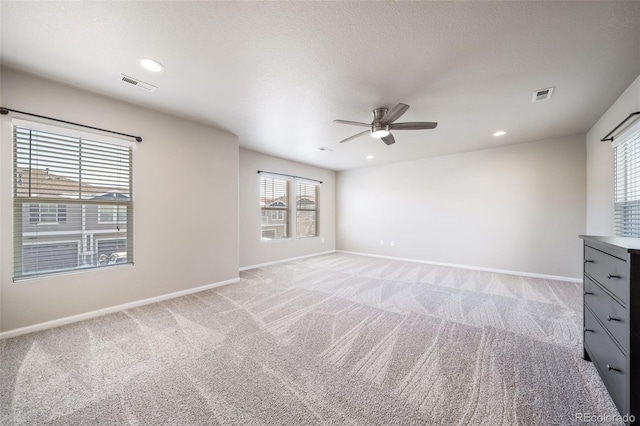 empty room featuring light colored carpet and ceiling fan