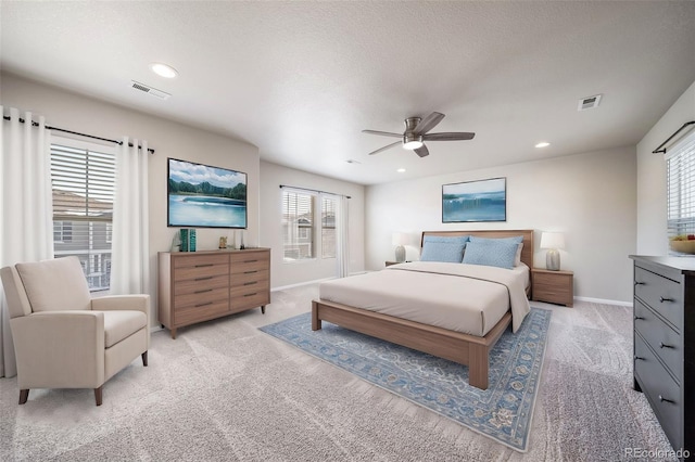 carpeted bedroom featuring a textured ceiling and ceiling fan