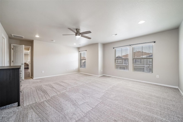 unfurnished living room featuring ceiling fan and light carpet